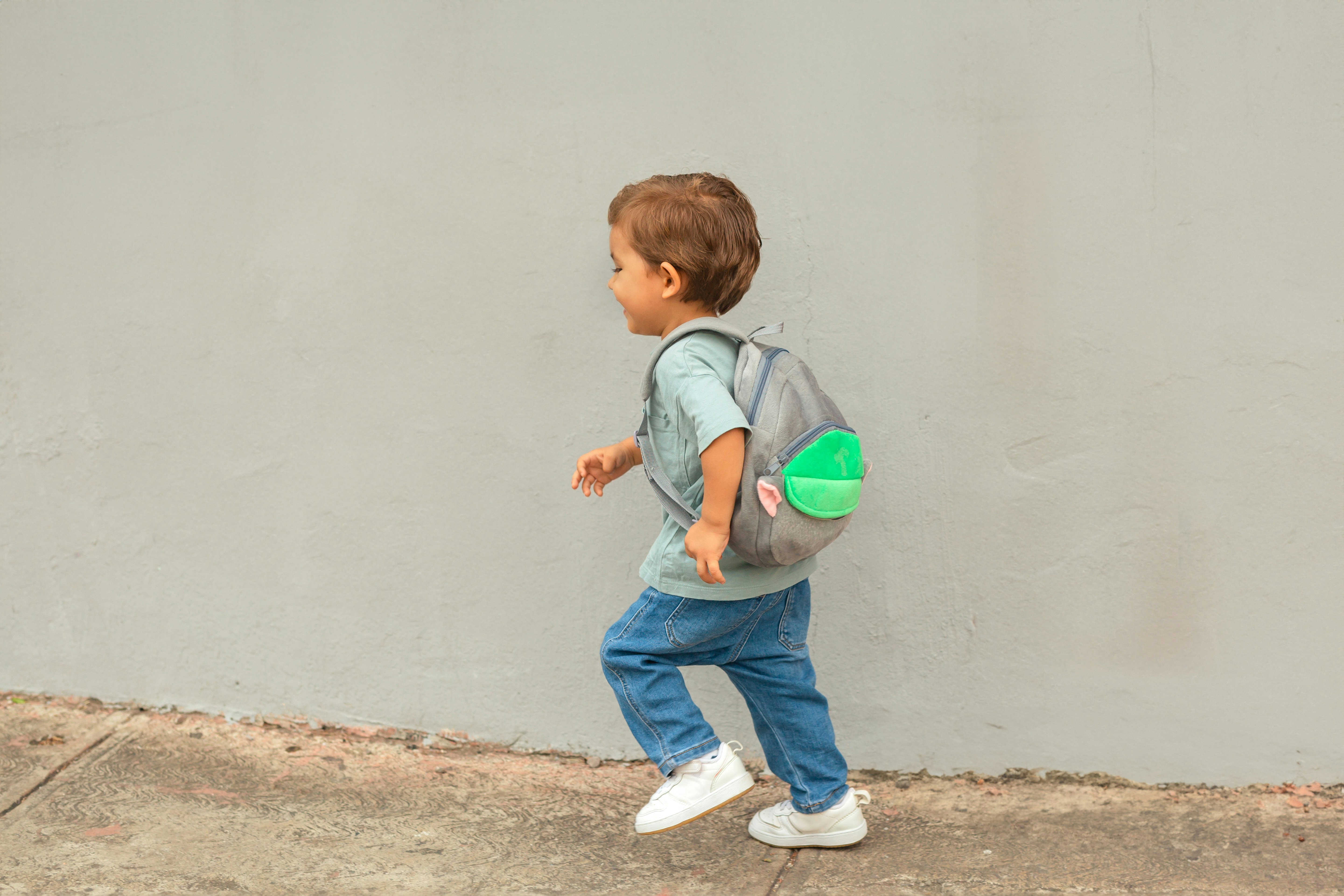 Parent waving goodbye to a child at school
