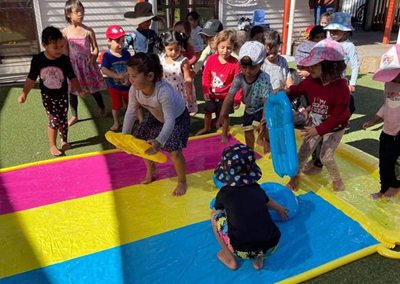 Children playing with colourful blocks on a rug