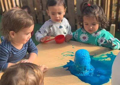 Child painting with watercolors on an easel
